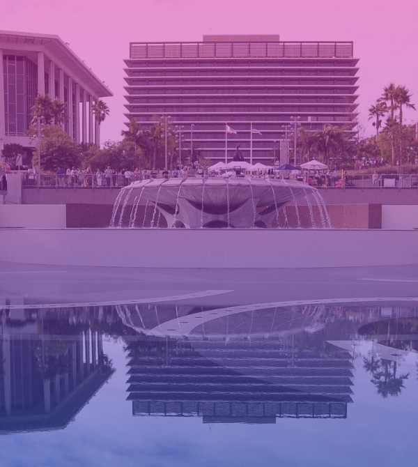 Image with gradient color overlay with water fountain & buildings in view